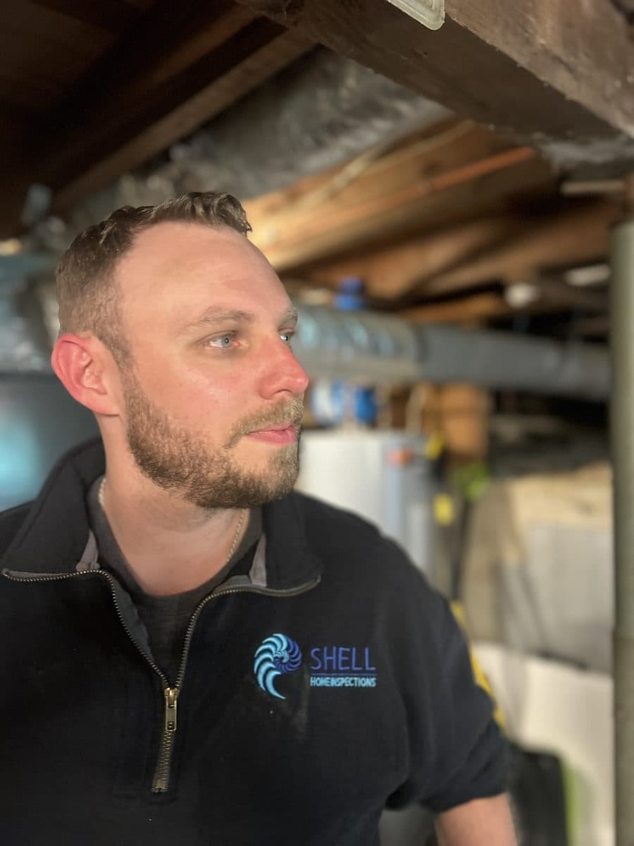 Matt Thompson inspecting a crawlspace at Shell Home Inspections