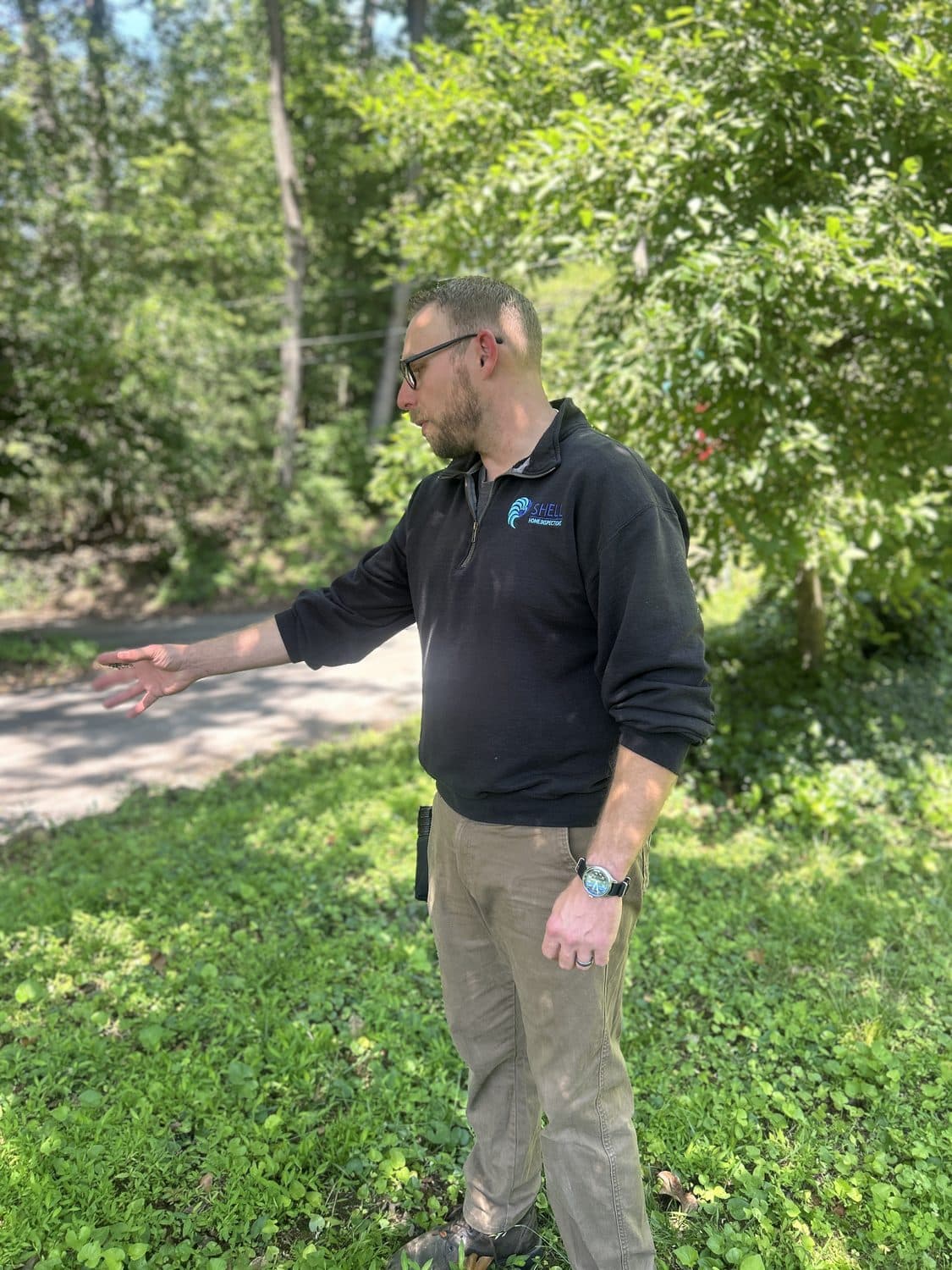 Matt assessing exterior conditions during a home inspection